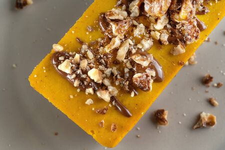 Homemade pumpkin pie with chocolate, and nuts. Sprinkled with walnuts.の写真素材