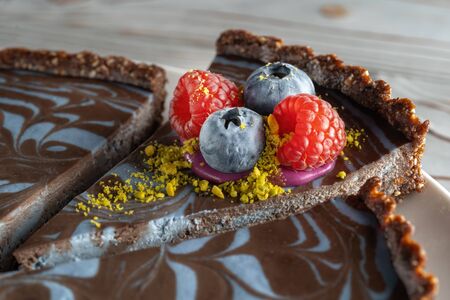 Chocolate cake with nuts, decorated with berries, blueberries and raspberries.の写真素材