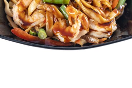 Wok with shrimp in a beautiful black plate. Top view, copy space.の写真素材
