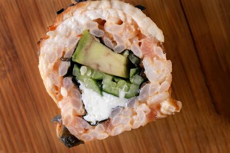 Sushi rolls with eel, avocado, cream cheese. Lies on a bamboo board. Top view.の写真素材