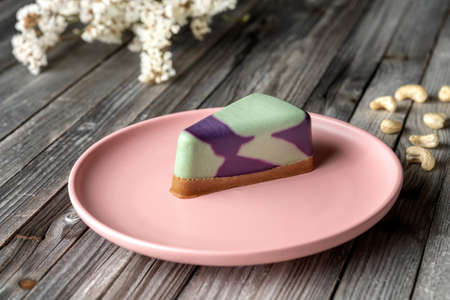 Blueberry cake, lemon, mint. Vegan, lactose free and sugar free. Laid on a pink plate. On a wooden background in rustic style.の写真素材