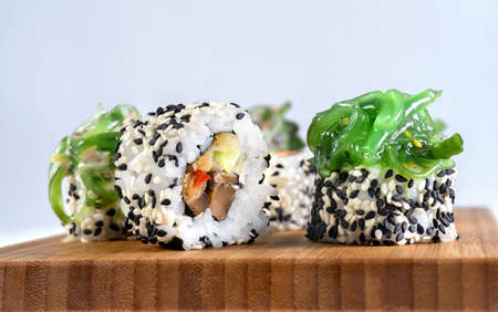 Shiitaki and chuka, beautiful rolls decorated with seaweed. Sprinkled with white and black sesame seeds.の写真素材