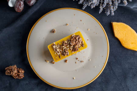 Homemade pumpkin pie with chocolate, and nuts. Sprinkled with walnuts.の写真素材