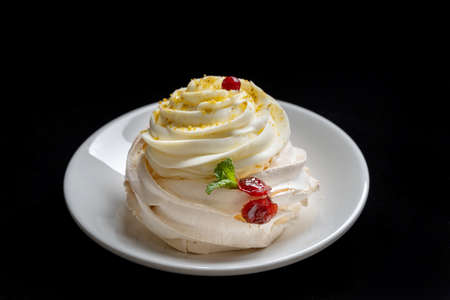 Pavlova meringue cake with fresh berries on black background.の写真素材