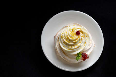 Pavlova meringue cake with fresh berries on black background.の写真素材