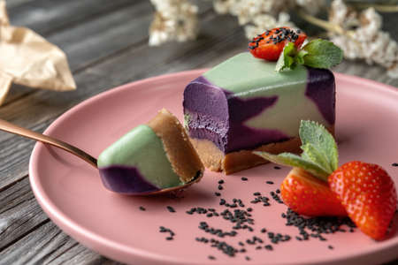 Blueberry cake, lemon, mint. Vegan, lactose free and sugar free. Laid on a pink plate, Ð° small piece is broken off and the structure of the cake is visible.の写真素材
