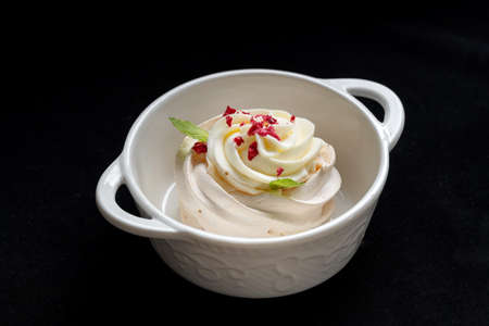Pavlova meringue cake with fresh berries on black background.の写真素材