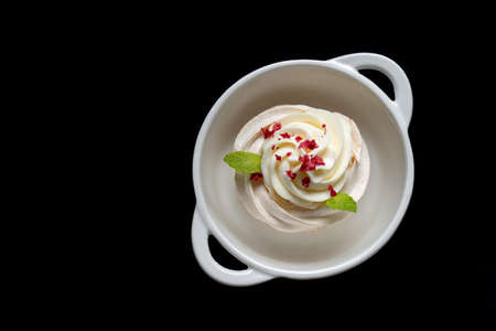 Pavlova meringue cake with fresh berries on black background.の写真素材