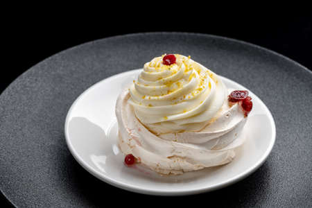 Pavlova meringue cake with fresh berries on black background-2.の写真素材