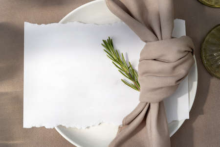 A plate with a white sheet on it. Wedding table with seating for guests.の写真素材