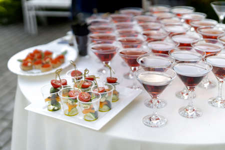 Set of cold snacks, with canapes in the foreground.の写真素材