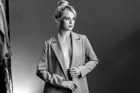 Sexy young blonde, a jacket dressed on a naked body.の写真素材