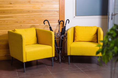 Stylish interior of hall with beautiful orange armchairs and accessories.の写真素材
