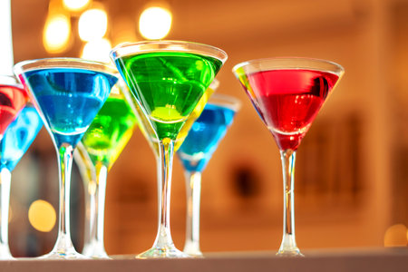 Variation alcoholic drinks served on bar counter. Colored drinks in glasses.の写真素材
