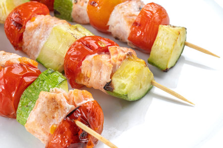 Salmon kebab with zucchini and a beautiful red tomato.の写真素材