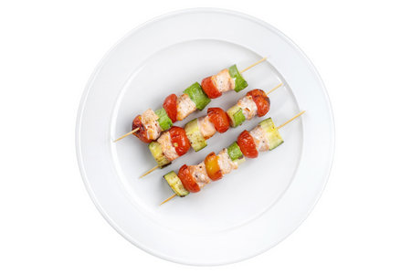 Salmon kebab with zucchini and a beautiful red tomato.の写真素材