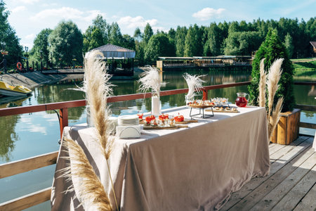 Terrace beside lake in warm summer evening, luxury catering.の写真素材