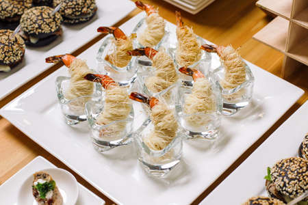 Catering. Shrimp on a plate, shrimp in wheat thread.の写真素材