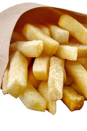 Potatoes fries in a little paper bag on a black mirrored background.の写真素材