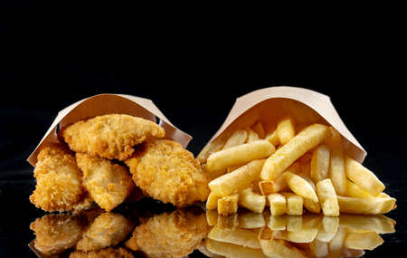 Image of the fried chicken and deep-fried fish pieces. Poured out of sachets.の写真素材