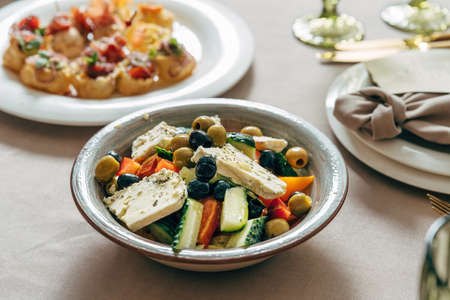 Greek salad with feta cheese, juicy tomatoes, red pepper, cucumber and lettuceの写真素材