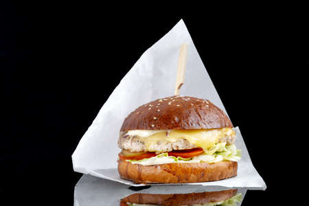 Delicious hamburger served on black background. Black mirror surface. Close-upの写真素材