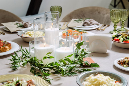 Beautiful table setting with candles and utensilsの写真素材