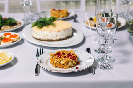 Wedding table with treats, beautiful setting. In the foreground, a meat salad with pomegranate seeds.の写真素材
