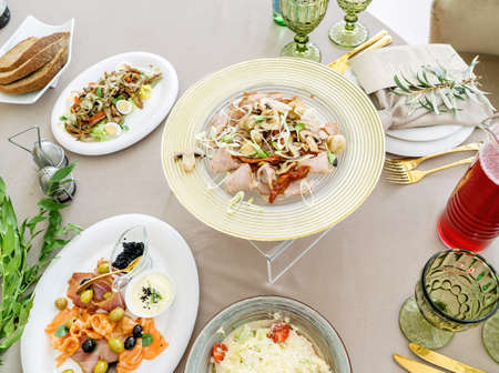 Beautiful festive table, with Greek salad with feta cheese.の写真素材