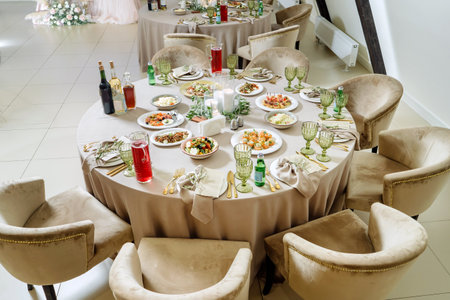 Beautiful served tables, wedding event. Lots of food and drinks.の写真素材