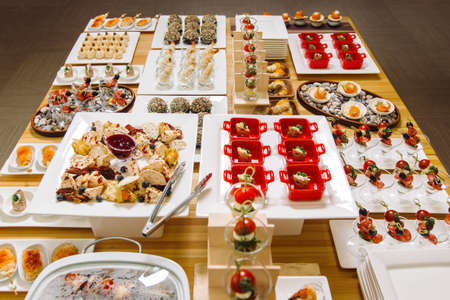 Mini burgers with meat on the table prepared for the guests of the event. Catering and guest meals during the event.の写真素材
