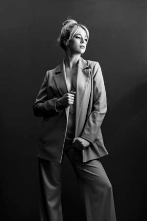 Sexy young blonde, a jacket dressed on a naked body. A detached look a little to the side.の写真素材