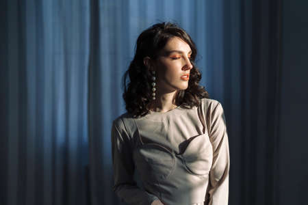 Elegant lady portrait.Pearls jewelry set posing against the backdrop of beautiful curtains.の写真素材