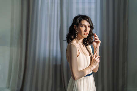 Close up studio portrait of a pretty brunettes looking straight at the camera and opening your mouth a little.の写真素材