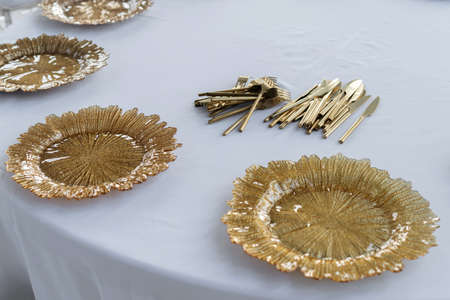 Beautiful served table, golden glass dishes, 45 view. Wedding event, luxury catering.の写真素材