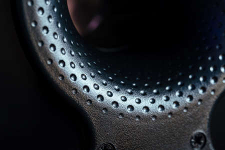 Bass reflex macro, black plastic. Studio light, fixing bolts visible.の写真素材