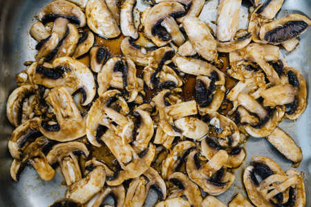roasted mushrooms champignons on an iron baking sheet. Catering blanks.
