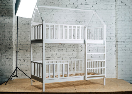 The image of the childs bed against the backdrop of white bricks, illuminated by studio fixtures-2.の写真素材