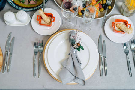 Decorative folded napkin on the Christmas table. Nicely set table.の写真素材