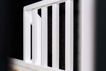 The image of the grates childs bed against the backdrop of the black ceiling.の写真素材