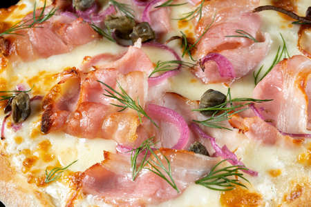 Pizza with capers, bacon and red onions.の写真素材