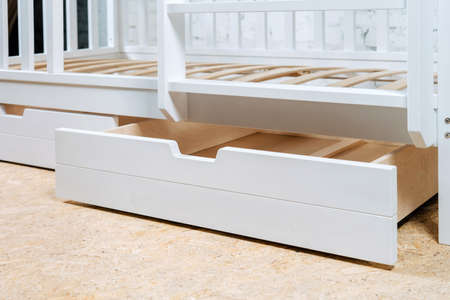 The image of the childs bed, bottom view of the storage drawers. White beautiful furniture.の写真素材