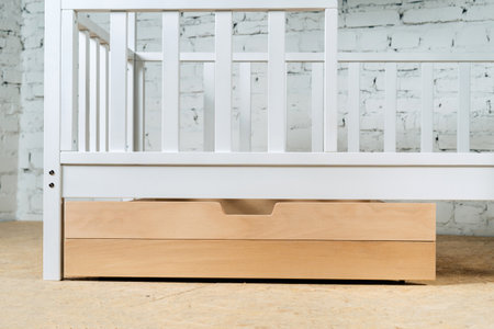 The image of the childs bed, bottom view of the storage drawers. An unpainted drawer.の写真素材