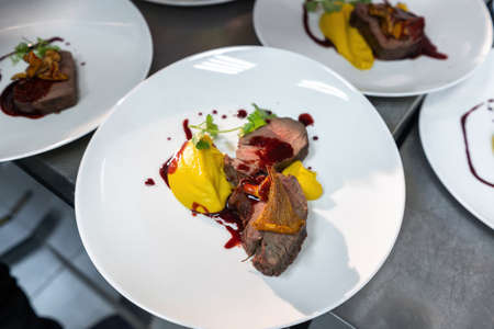 Beef cheek steak, caramelized in wine sauce with chanterelles in a white plate.の写真素材