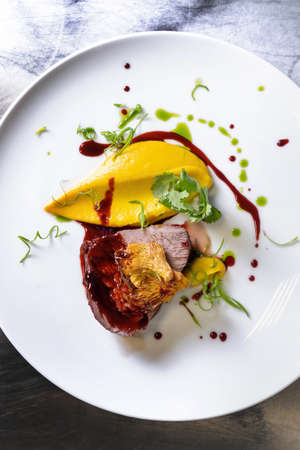 Beef cheek steak, caramelized in wine sauce with chanterelles in a white plate.の写真素材