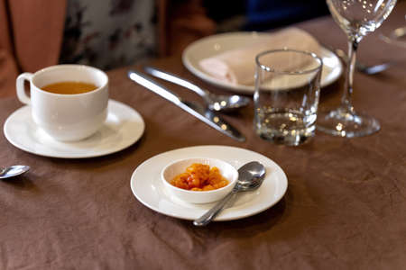 Juicy ripe cloudberry northern in a plate. Many plates on the table.の写真素材