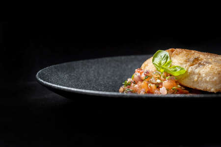 Delicious fish fry served on a beautiful plate, laid out on tartare. Very voluminous pictureの素材 [FY310182392107]