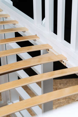 Close-up wooden elements of an orthopedic base of a bed. Interior structure of furniture.