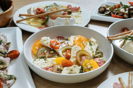 Salad with tomatoes, pine nuts and cheese. Horizontal photoの写真素材