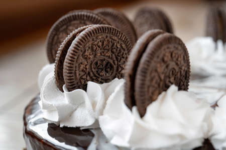 Cake with chocolate cookies and whipped cream. Drizzled with chocolate. Clouse-upの写真素材